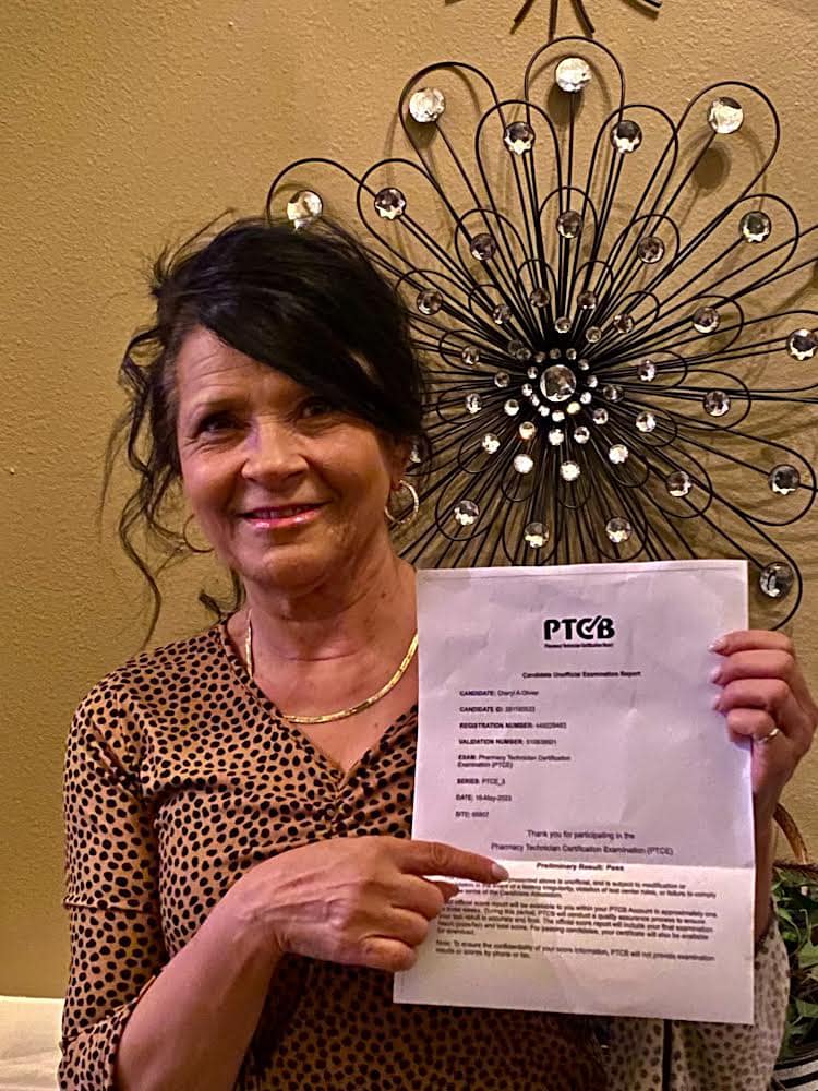 Cheryl, a jubilant woman in her 40s, proudly displays her PTCB national exam certificate, attributing her success to LW Pharmacy Technician School, ready to embark on her new journey as a certified pharmacy technician.
